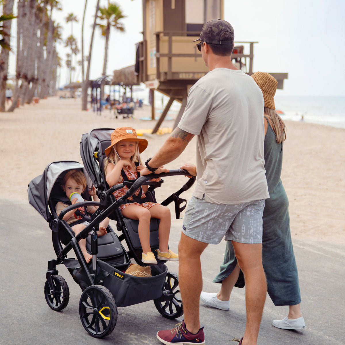 Kids riding in Veer Switchback / &Roll Stroller Frame