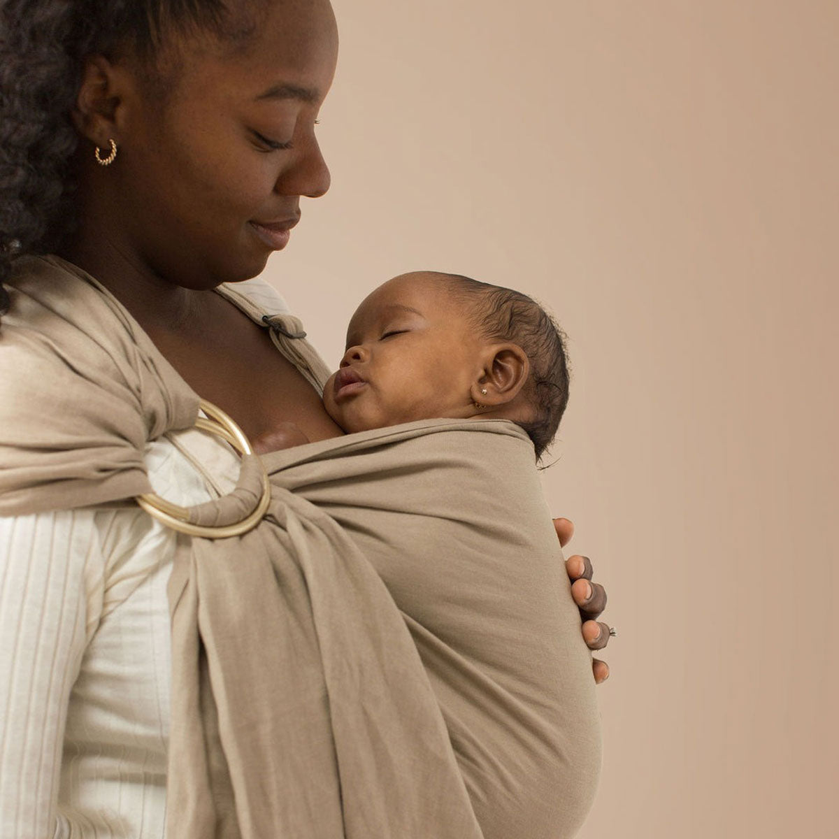 Mom wearing baby in WildBird Linen Sling - Desert Lark