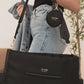 Woman carries JuJuBe Utility-Strap Tote - Black