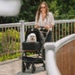 Woman pushing dog in Tavo Maeve + Roscoe 3-in-1 Pet Protection System - Medium Flex - Onyx