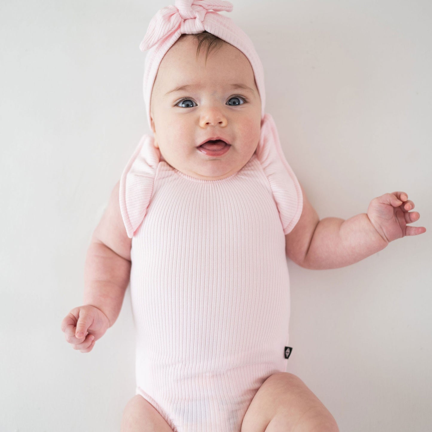 Kyte BABY Ribbed Sleeveless Ruffle Leotard - Sakura