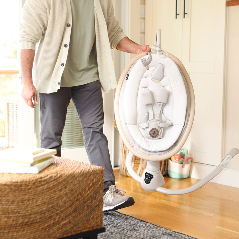 Dad carrying Maxi-Cosi Cassia Swing - Classic Oat