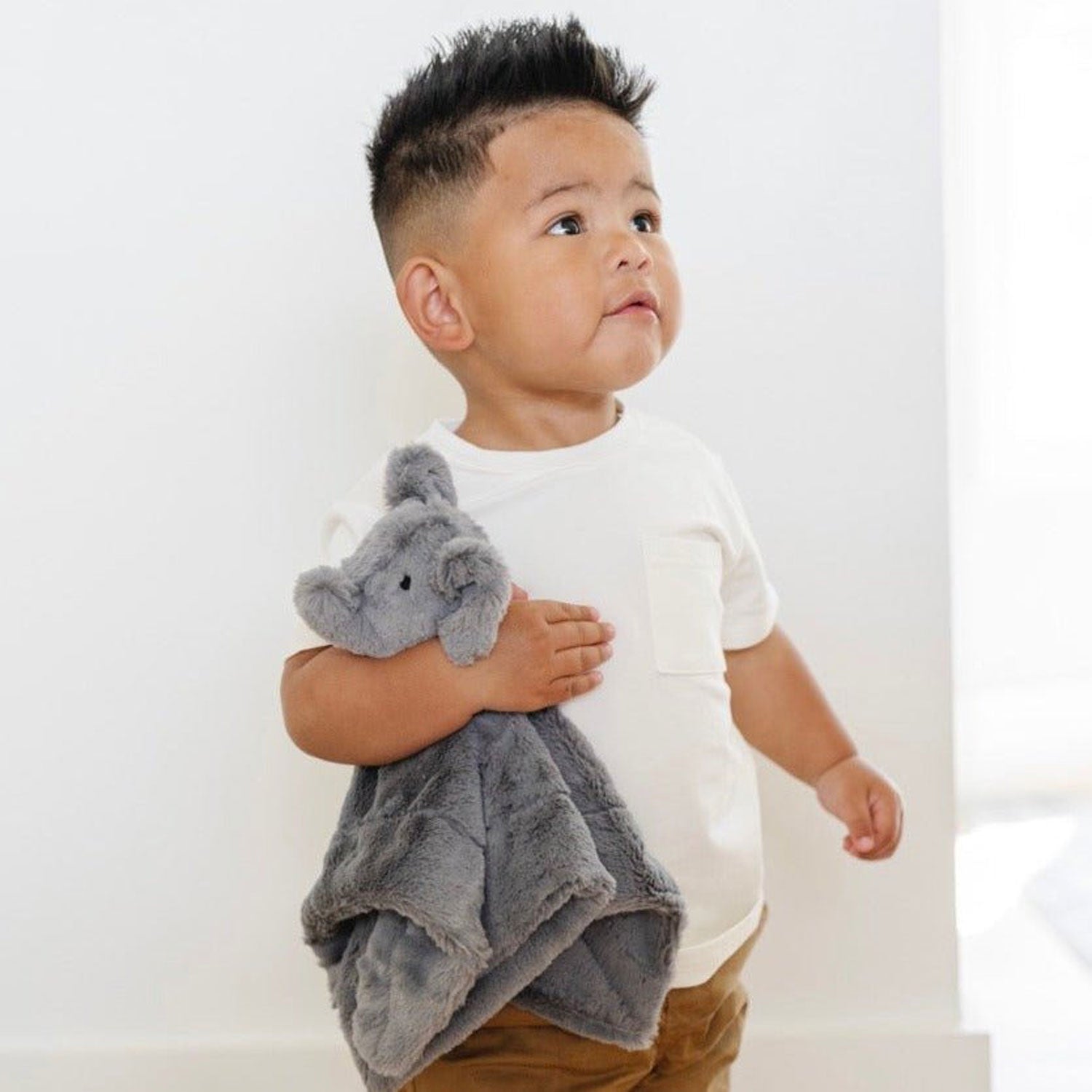 Toddler boy holding Saranoni Stuffed Animal Lovey - Elephant