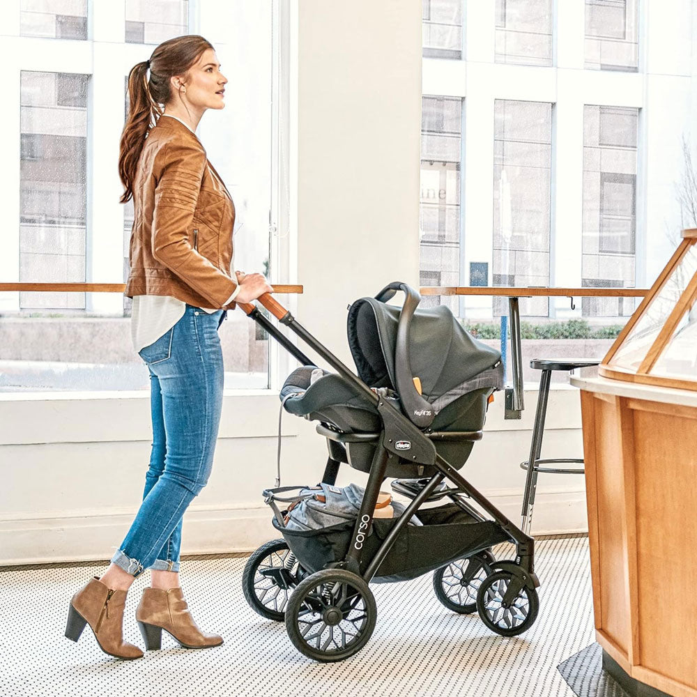 Woman pushing Chicco Corso LE Modular Travel System - Hampton
