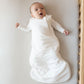 Newborn baby lays in crib in Kyte BABY Sleep Bag - Cloud - 1.0 Tog