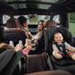 Two kids in backseat of car sitting in Romer Veni Convertible Car Seat - Peppercorn