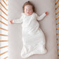 Baby girl sleeps in crib in Kyte BABY Sleep Bag - Cloud - 1.0 Tog