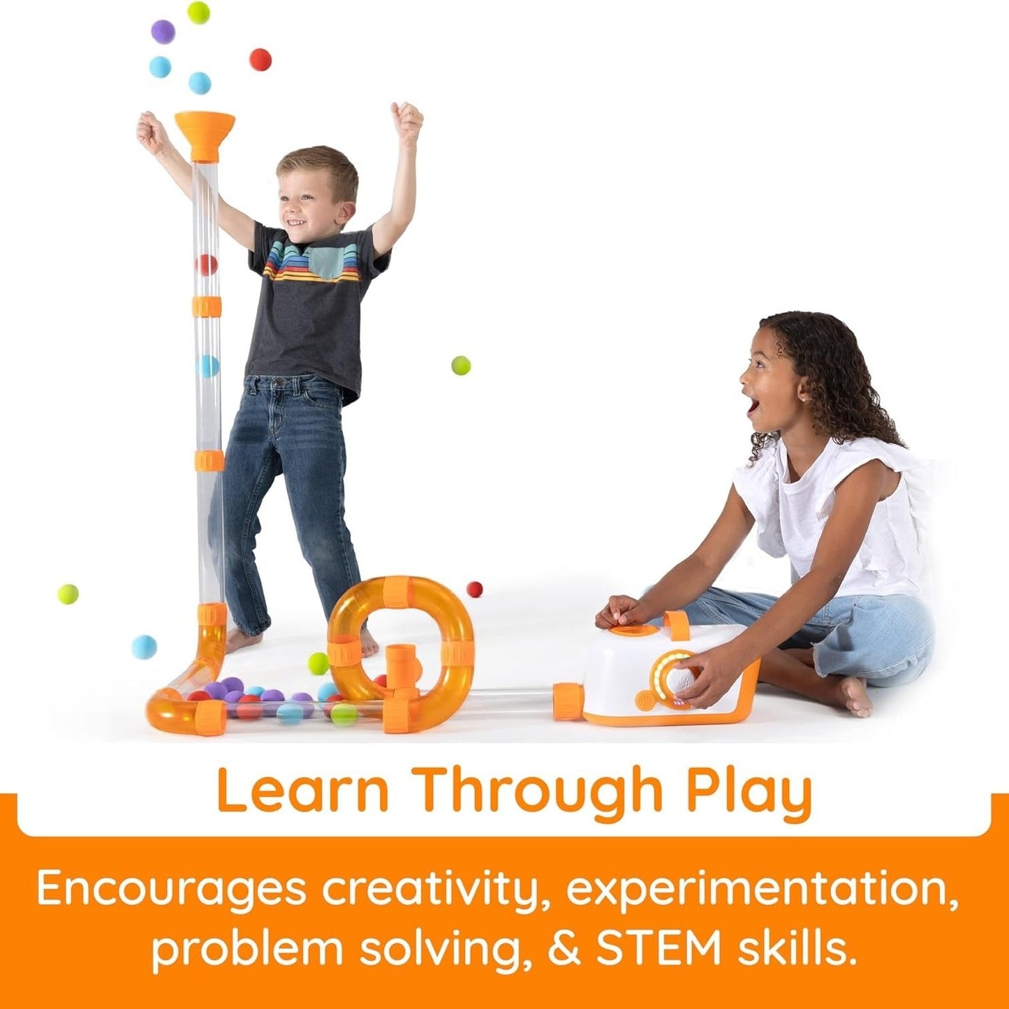 Two kids watch balls pop out of Fat Brain Toys Air Toobz