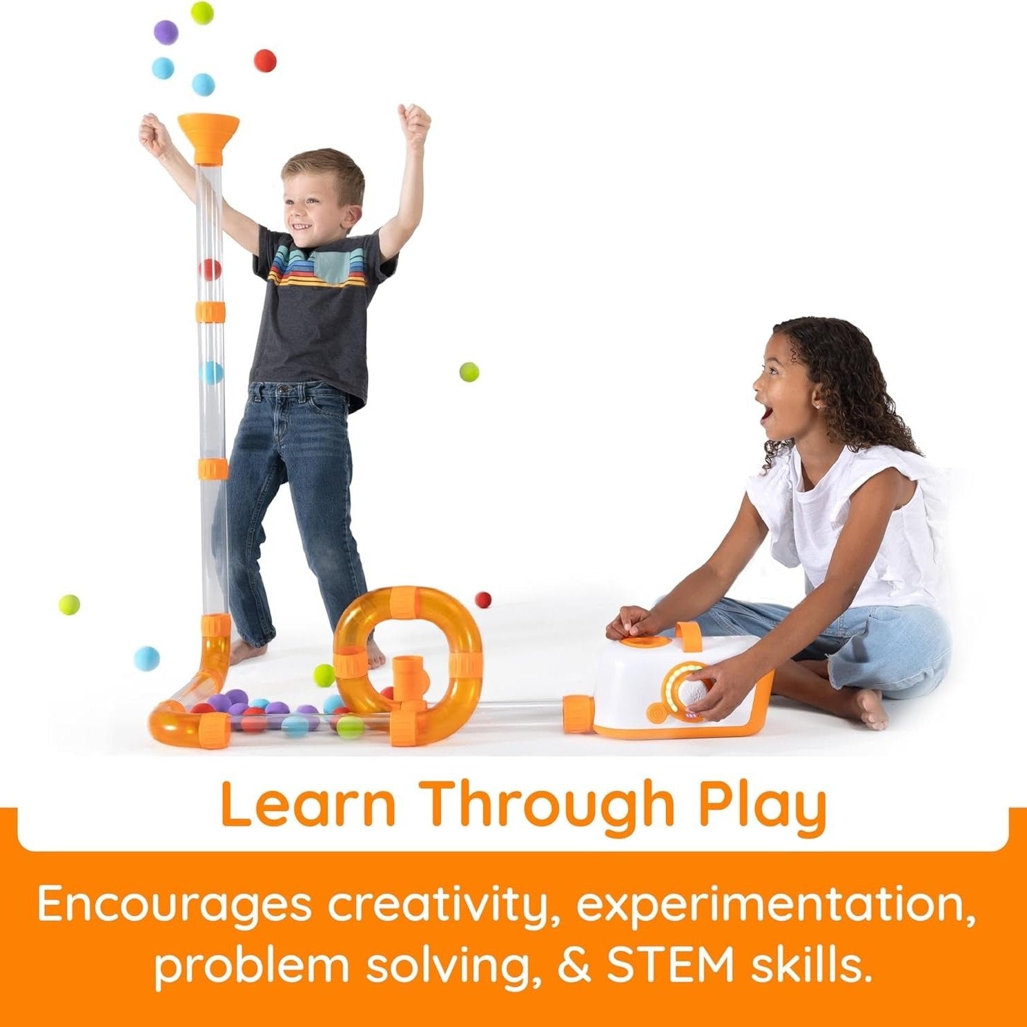 Two kids watch balls pop out of Fat Brain Toys Air Toobz