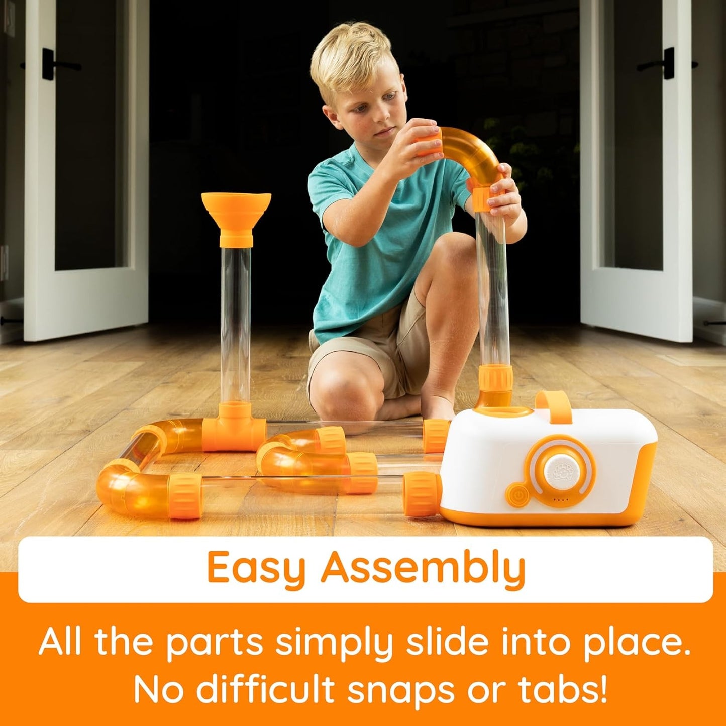 Boy builds with Fat Brain Toys Air Toobz
