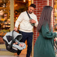 Dad carries baby in car seat of Maxi-Cosi Zelia2 Luxe+ 5-in-1 Travel System with Mico Luxe+ - Arctic Frost