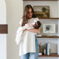 Mom holds baby wrapped in Saranoni Heirloom Cotton Knit Receiving Blanket - Cream