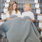 Kids snuggle together in Saranoni Waffle Knit Toddler Blanket - Elm