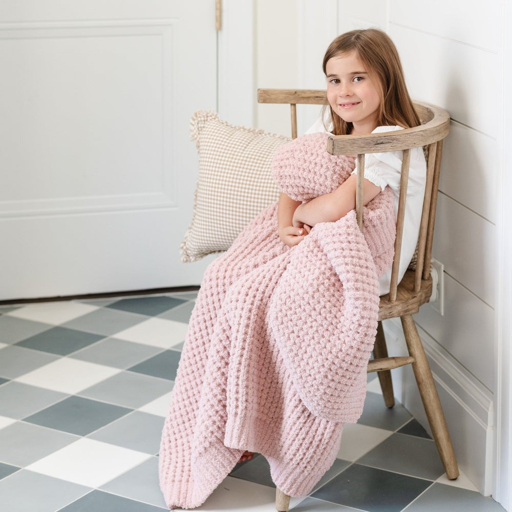 Little girl snuggles with Saranoni Waffle Knit Toddler Blanket - Rosette