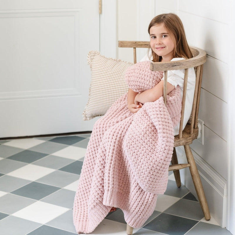 Little girl snuggles with Saranoni Waffle Knit Toddler Blanket - Rosette