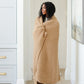 Woman wrapped in Saranoni Waffle Knit Throw Blanket - Allspice