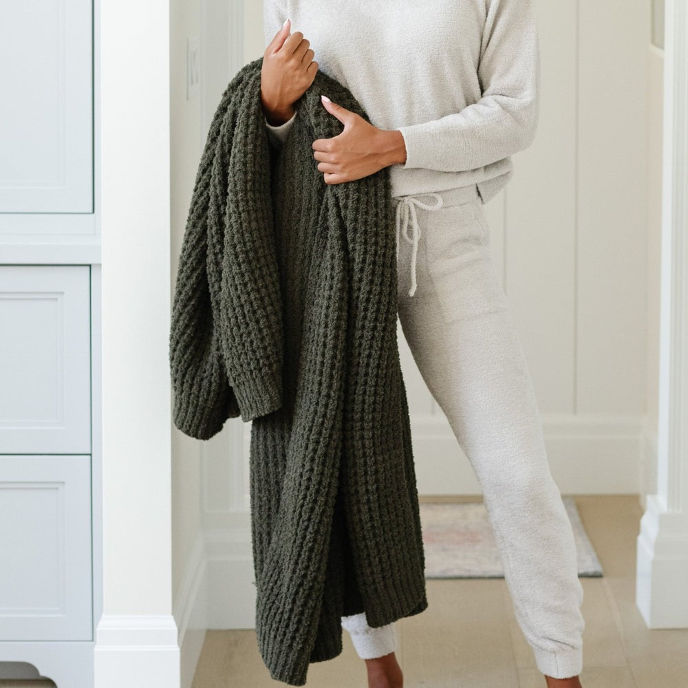 Woman holds Saranoni Waffle Knit Throw Blanket - Thyme