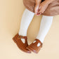 Little girl wearing Little Stocking Co Ribbed Knit Tights - Ivory