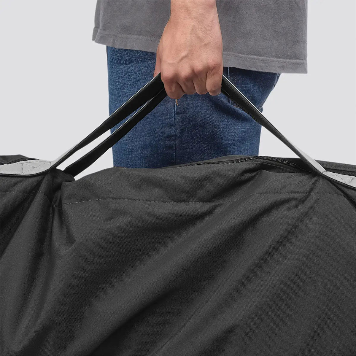 Man carrying stroller in UPPAbaby G-LUXE / G-LITE TravelSafe Travel Bag