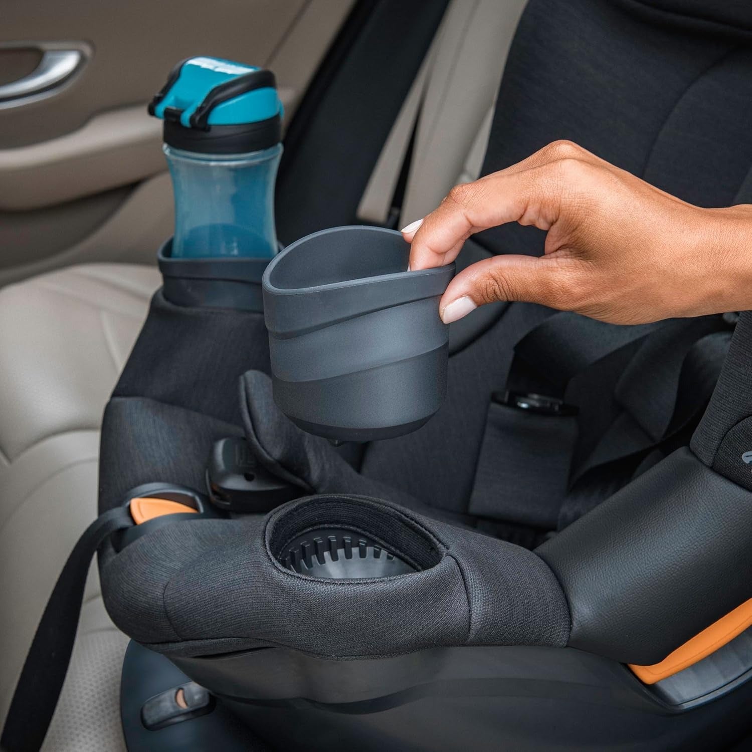 Parent removes cupholder of Chicco Fit360 ClearTex Rotating Convertible Car Seat - Black