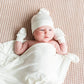 Baby wearing Kyte BABY Knotted Cap - Cloud