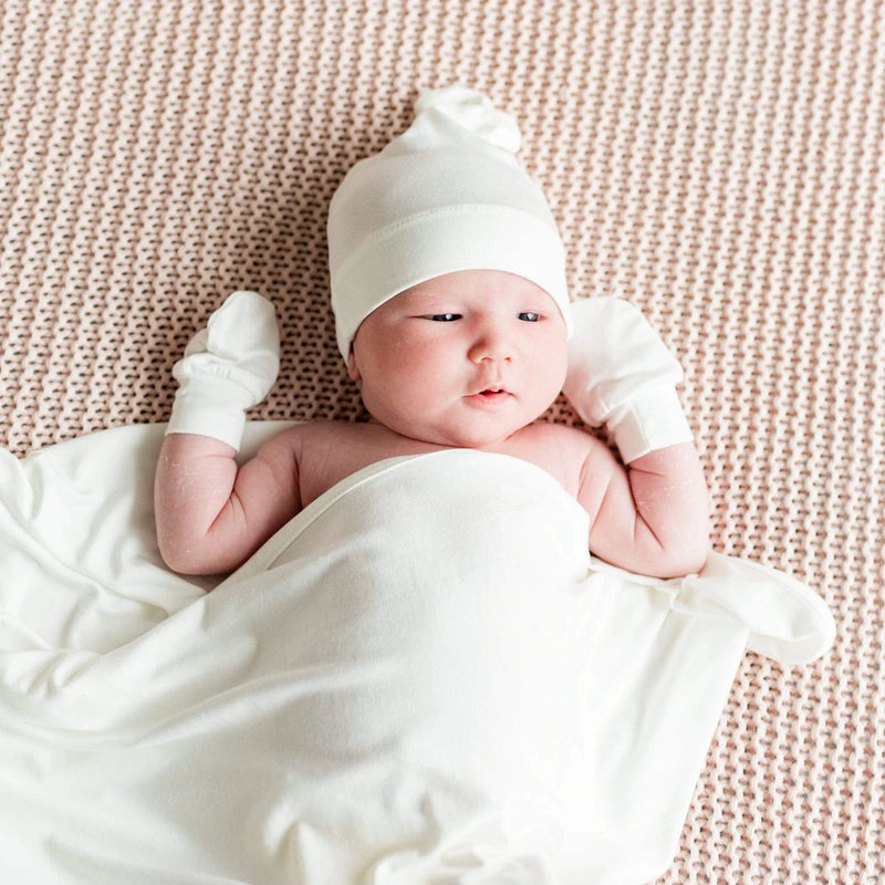 Baby wearing Kyte BABY Knotted Cap - Cloud