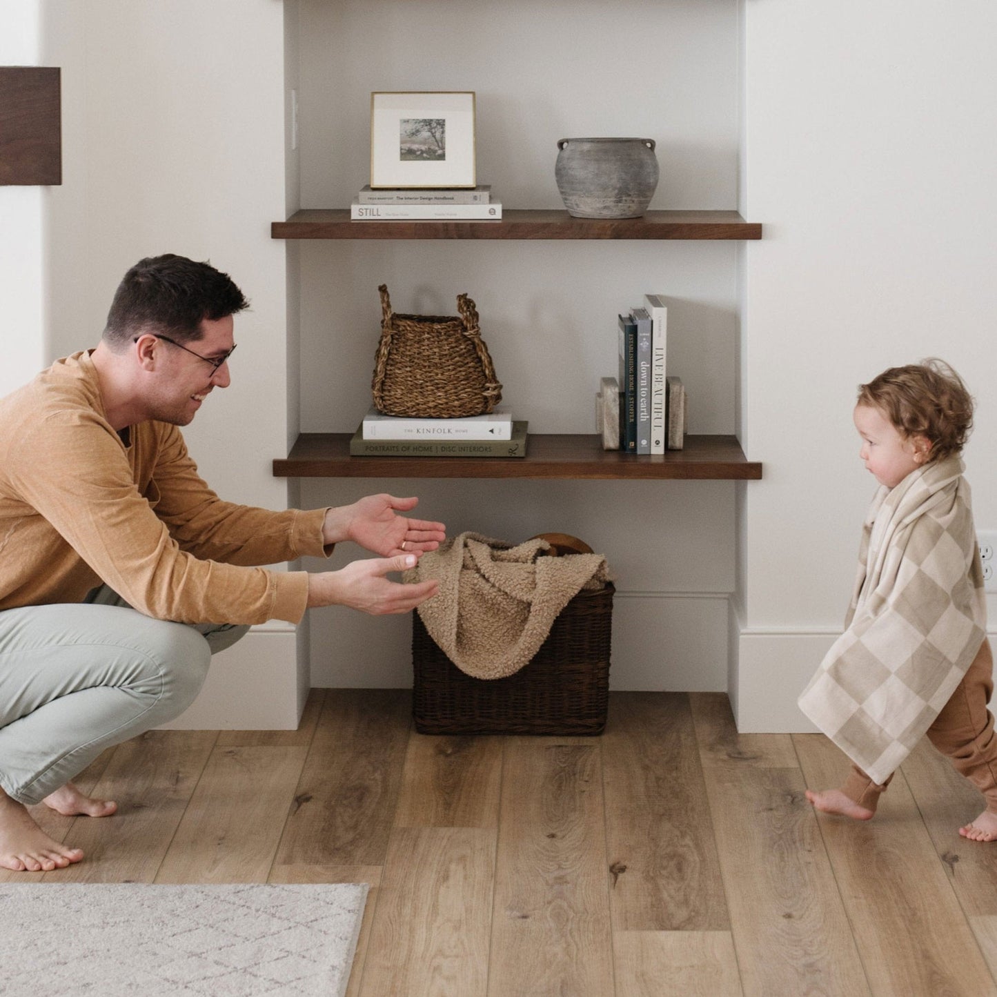 Toddler wrapped in Saranoni Receiving Minky Stretch Blanket - Neutral Checkered walks to dad