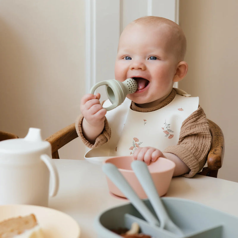 Baby chewing on Mushie Silicone Fresh Food Feeder 2-Pack - Cambridge Blue