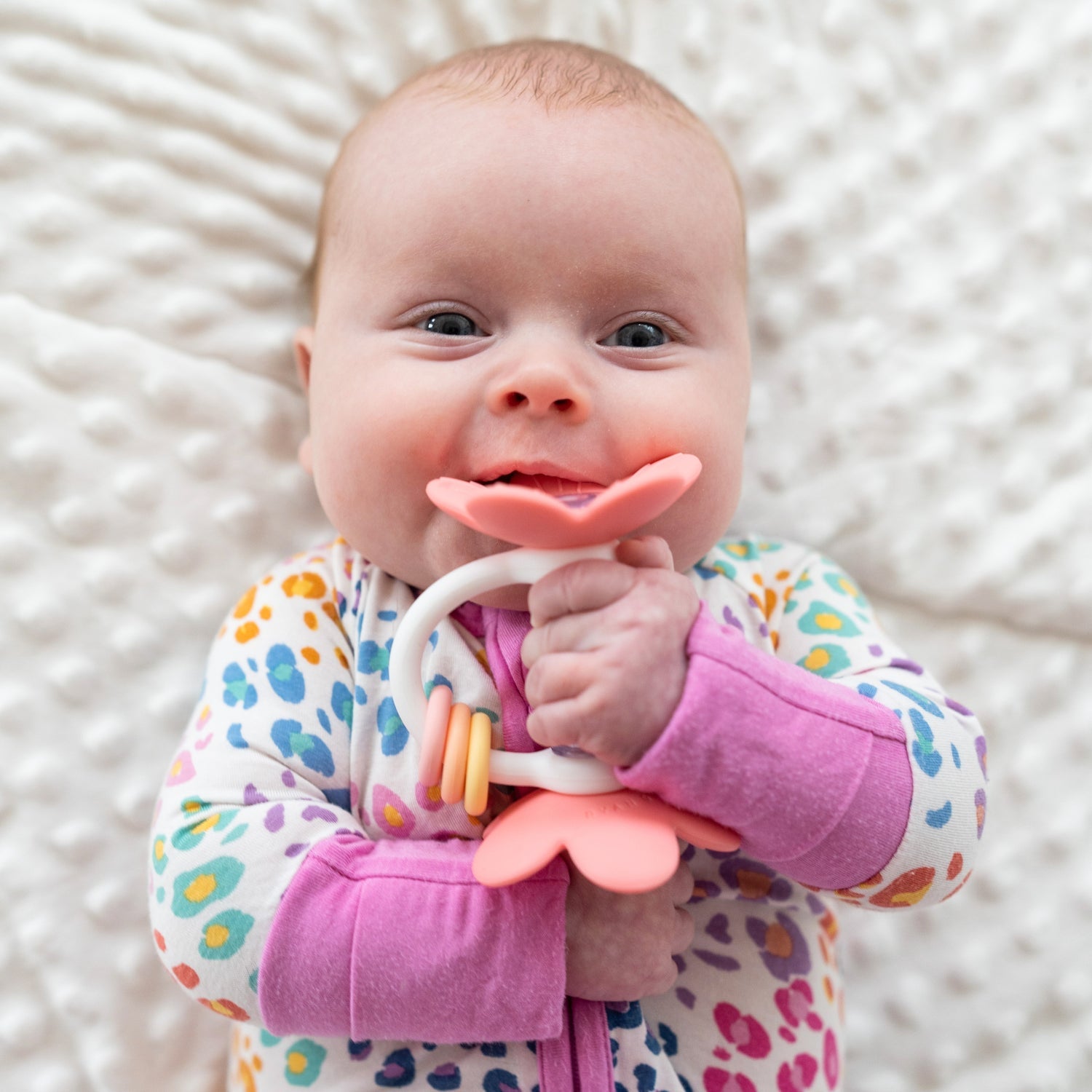 Baby girl chews on Ryan and Rose Flower Teether Rattle Toy - Shortcake
