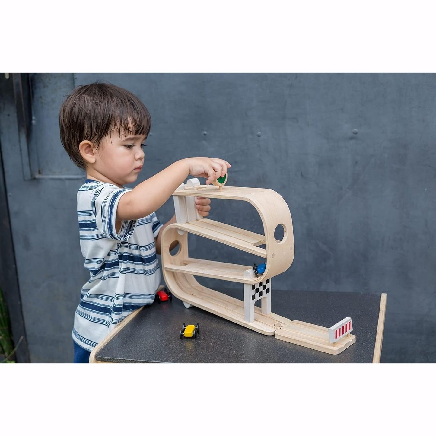 Boy plays with PlanToys Ramp Racer