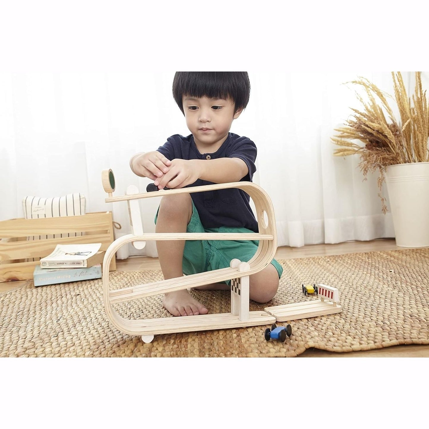 Boy plays with PlanToys Ramp Racer