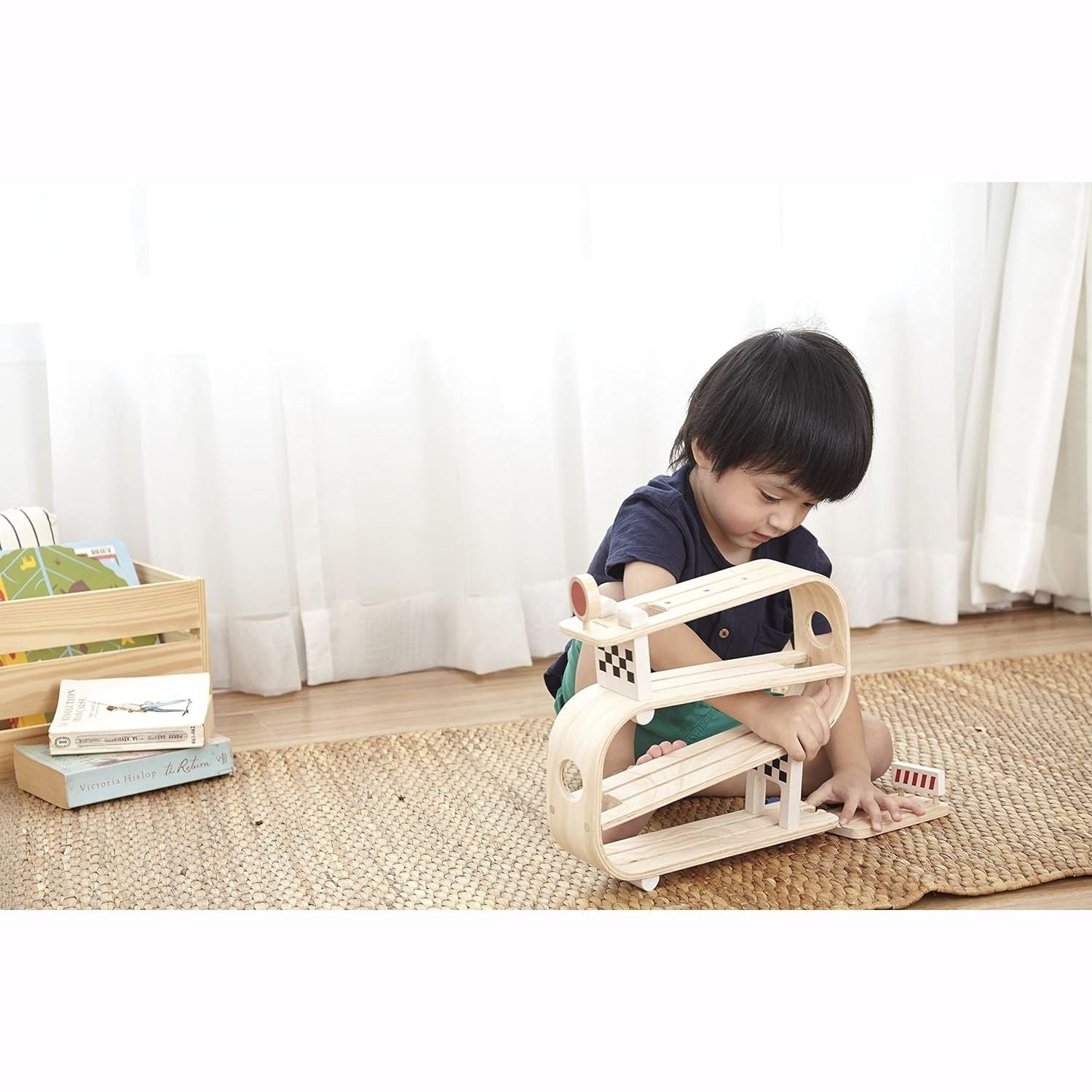 Boy plays with PlanToys Ramp Racer
