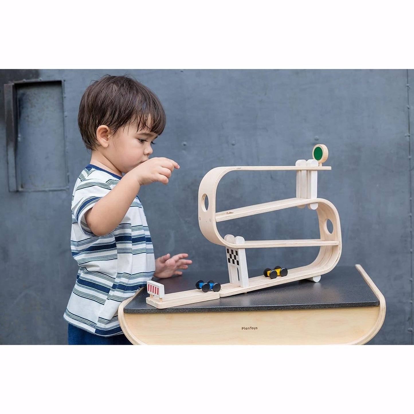 Boy plays with PlanToys Ramp Racer