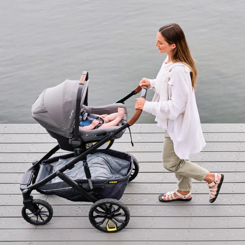Mom pushes baby in Veer Switch&Roll Leather Kit Luxe Bundle - &Roll Stroller Frame / Switchback Seat Luxe / Genuine Napa Leather Grips for Handle and Armbar - Saddle - Gray Granite
