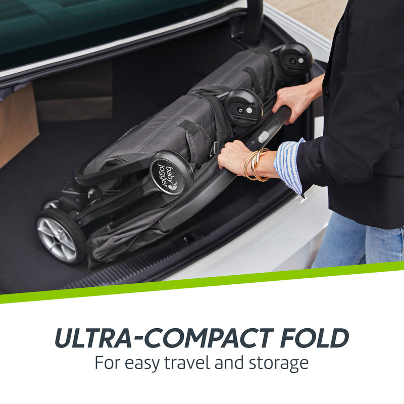Woman puts folded Baby Jogger City Tour 2 Double Stroller in car trunk