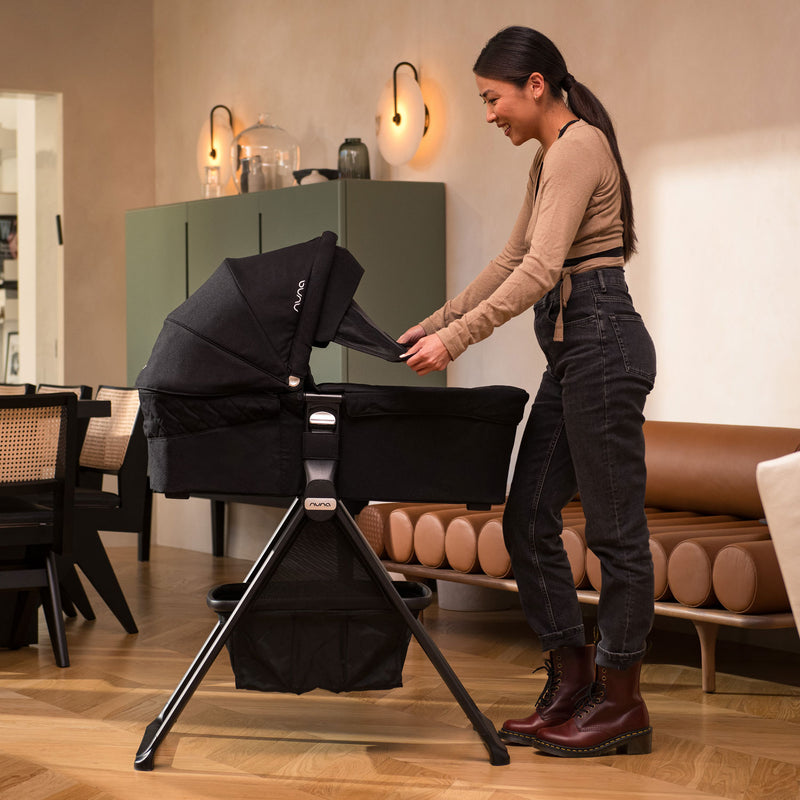 Mom using Nuna MIXX Series Bassinet + Stand - Caviar