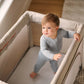 Toddler standing in playard UPPAbaby Organic Cotton Mattress Cover - REMI