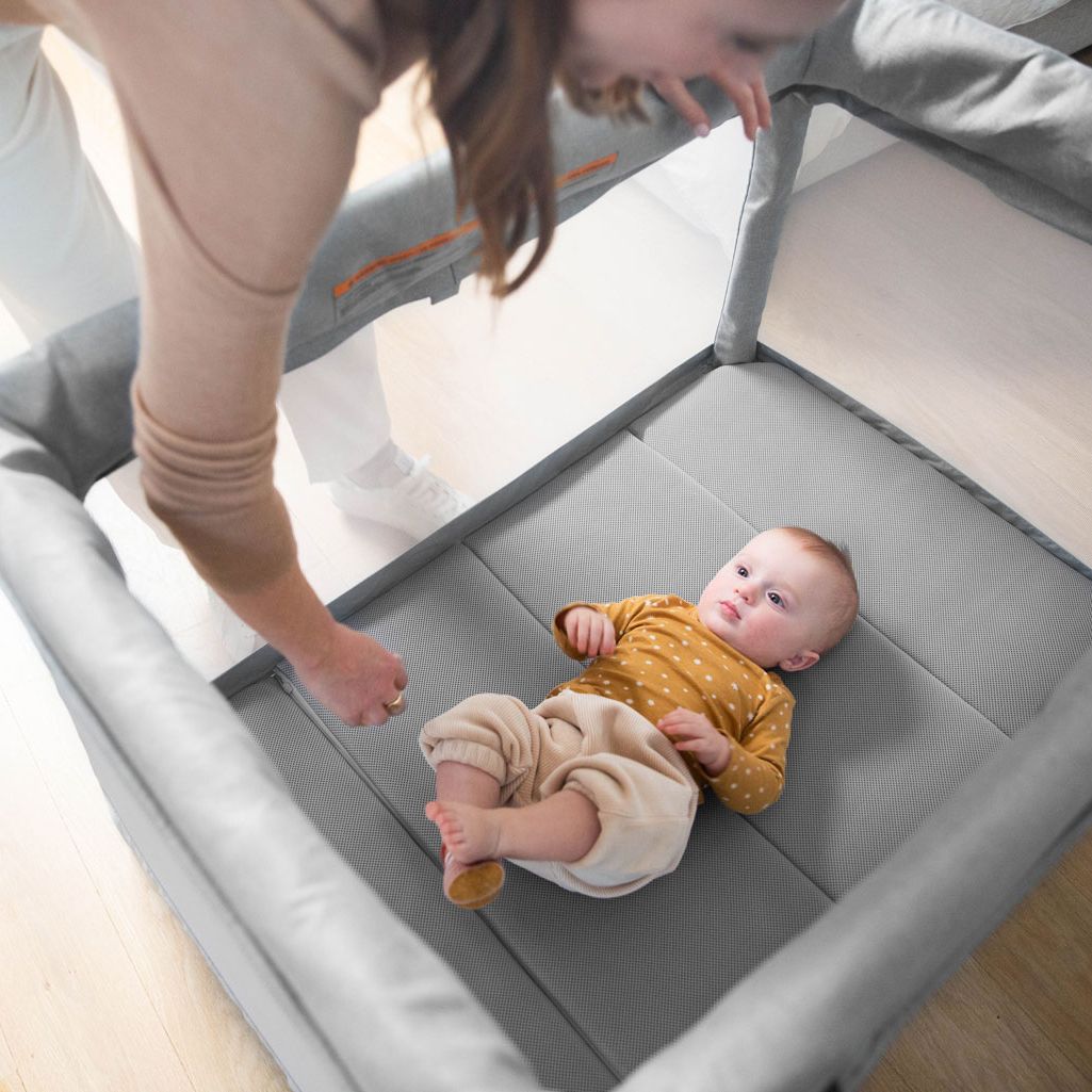 Baby laying inside UPPAbaby REMI Playard - Stella