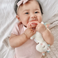 Baby chewing on Itzy Ritzy Ritzy Rattle Pal - Plush Rattle Pal with Teether - Unicorn