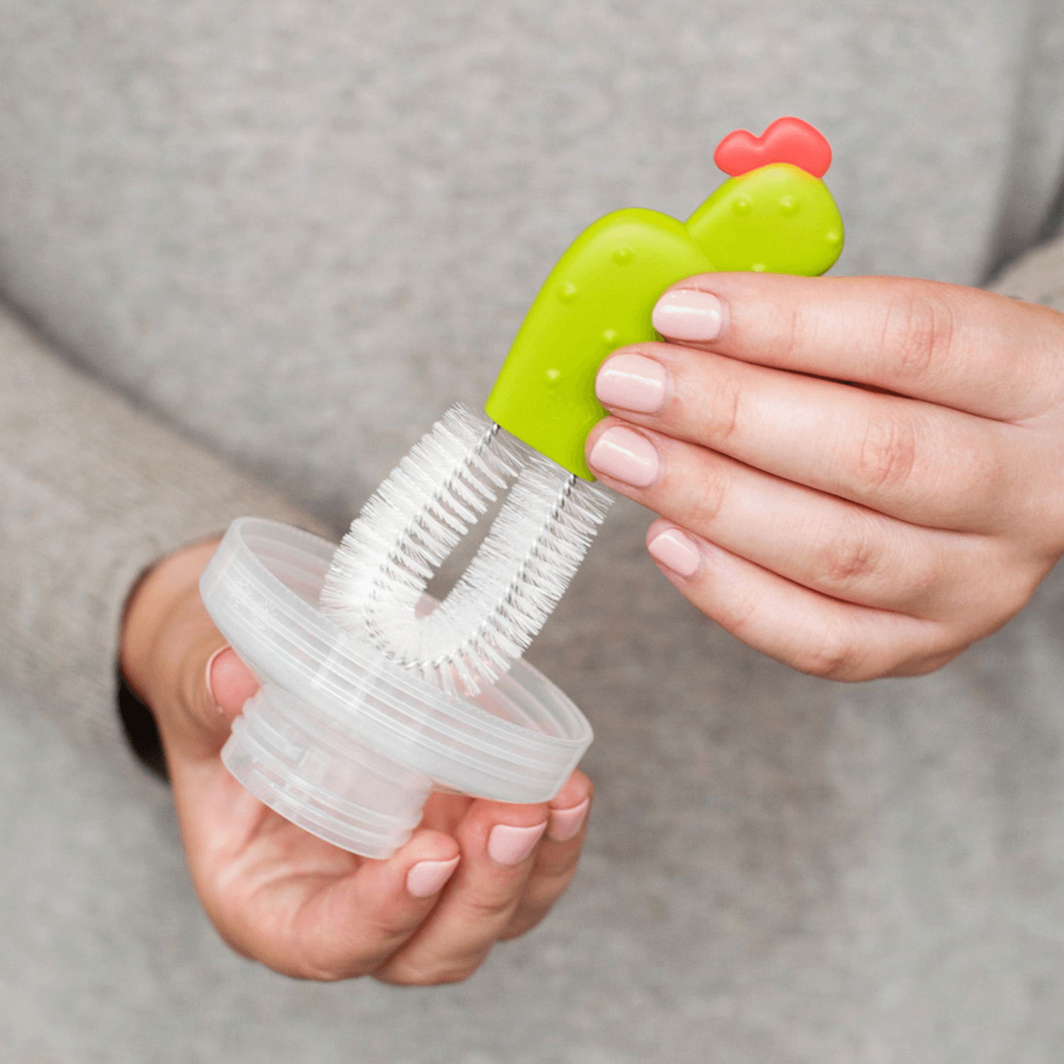 Woman using Boon CACTI Bottle Cleaning Brush Set - White/Green