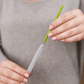 Woman using Boon CACTI Bottle Cleaning Brush Set - White/Green