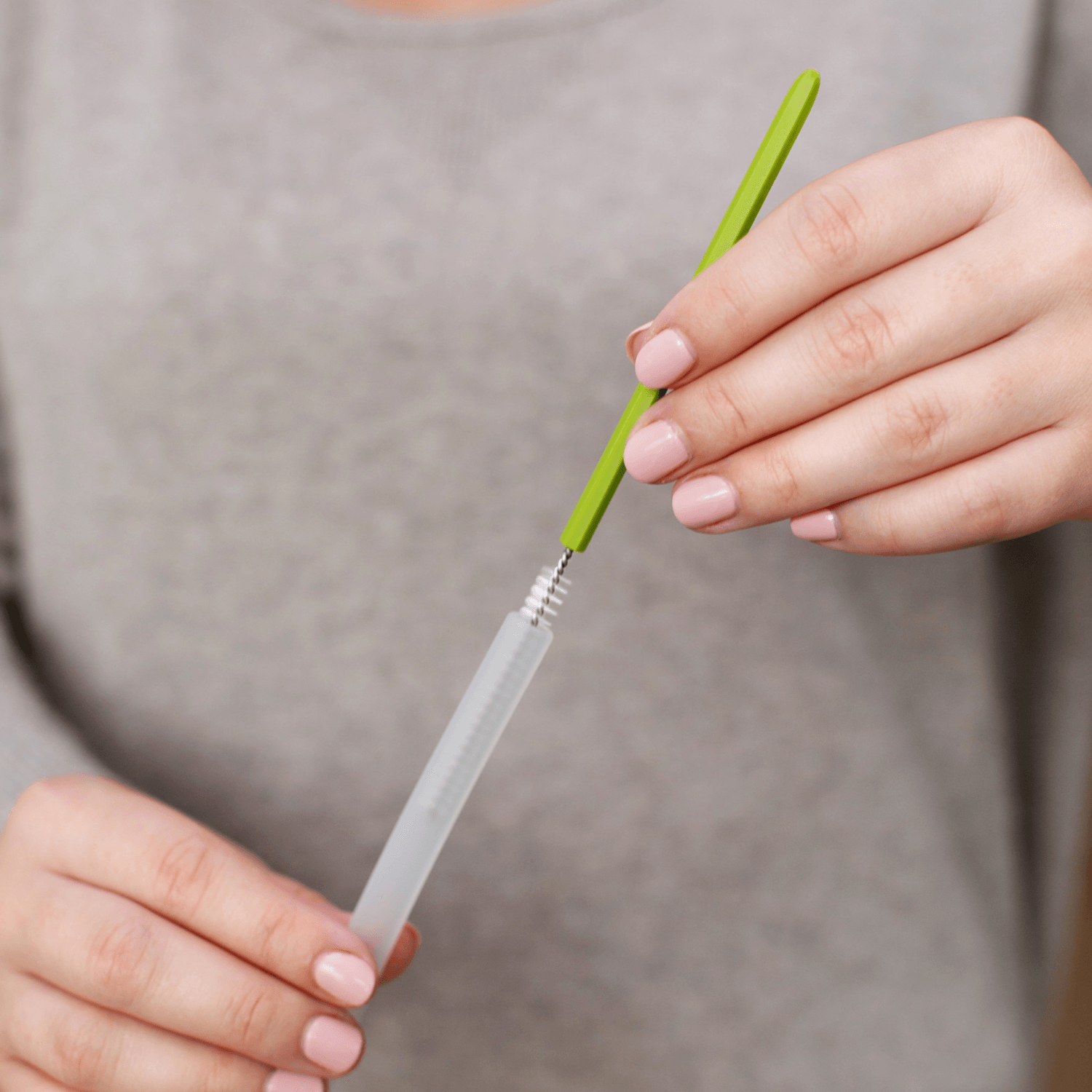 Woman using Boon CACTI Bottle Cleaning Brush Set - White/Green