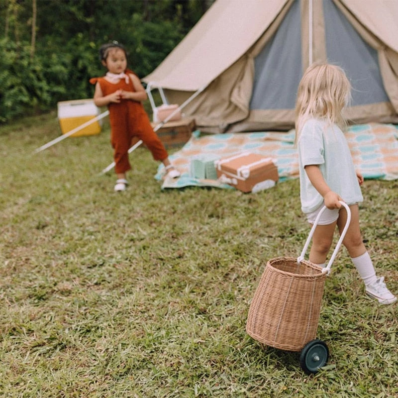 Girl holding Olli Ella Ratten Original Luggy - Natural