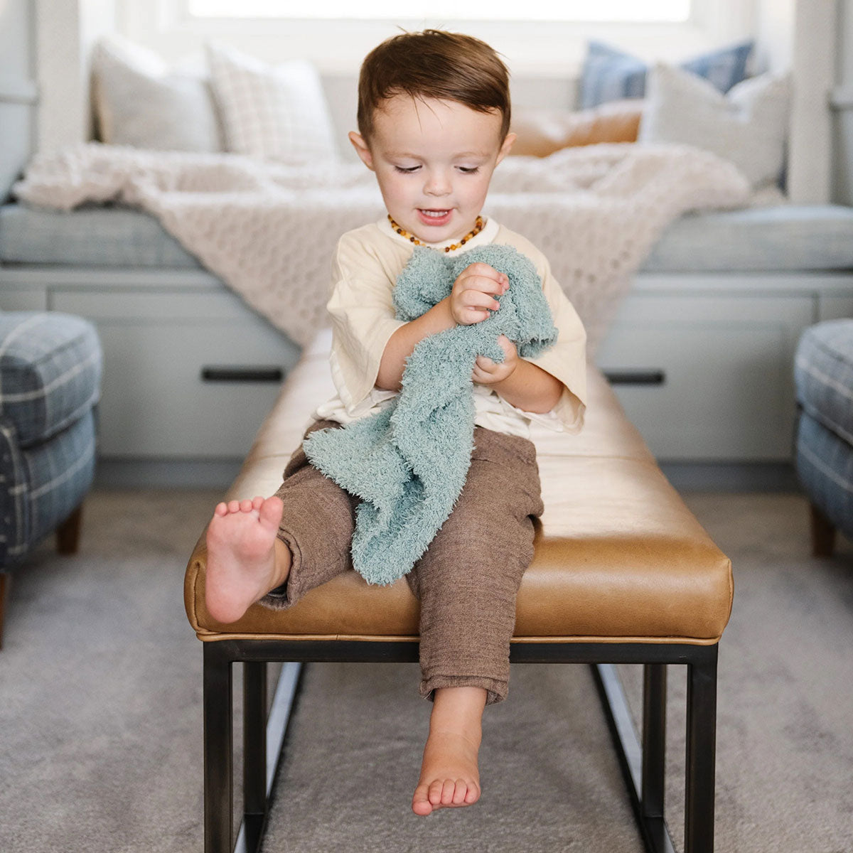 Little Boy holding Saranoni Mini Ribbed Bamboni Blanket - Surf